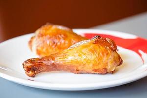 Roasted Chicken drumsticks on white plate