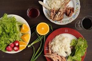 Dinner od turkey meat with rice, lettuce salad with radish photo