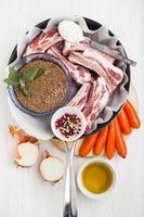 cooking ingredients in pan : raw ribs, green Lentils , carrots,
