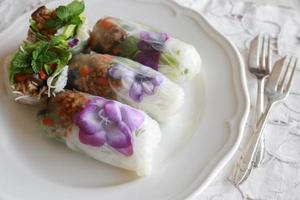 Homemade rice paper rolls with edible flowers photo