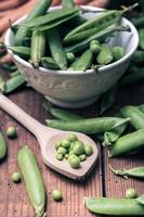 Pea pods in a bowl with spoon photo