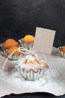 Cupcakes with empty tag on the wooden table photo