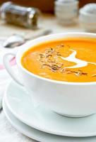 Vegetarian carrot-pumpkin cream soup with garlic and cumin