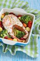Baked red salmon with vegetables photo