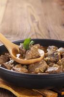 Beef stew - wooden background photo