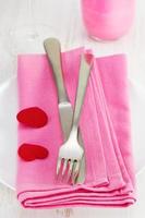 fork and knife on pink napkin photo