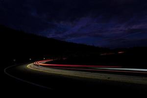 car light on interstate in mountain desert