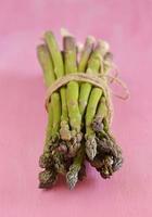 Asparagus on pink background photo
