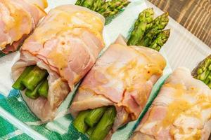 Asparagus wrapped in chicken and bacon photo
