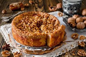 Piece of apple pie with walnut and sugar glaze photo