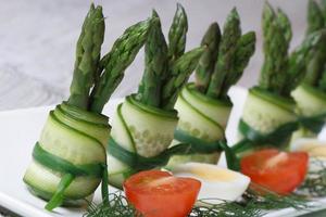Cucumber rolls with asparagus and green onions photo