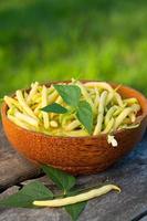 yellow kidney beans in a bowl on wooden table