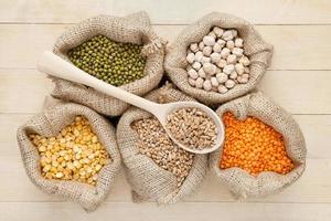 bags with red lentils, peas, wheat and green mung photo