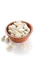 close up of raw haricot beans in wooden bowl photo