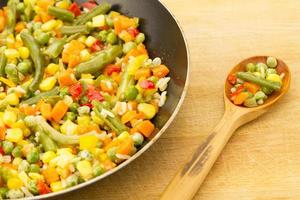 vegetable mix in the pan on wooden background photo