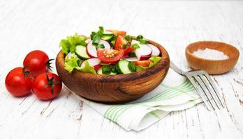 Spring salad with tomato, cucumbers and radish photo