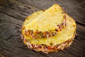Pineapple. Slice on wood. Organic fruit photo