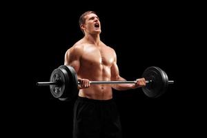 Muscular bodybuilder lifting weight photo