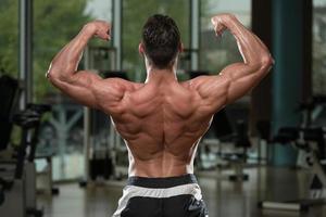 Bodybuilder Performing Rear Double Biceps Pose photo