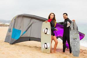 Family in wetsuits with surf boards photo