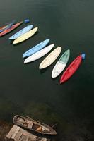 Old versus New. New and old Kayaks on lake photo