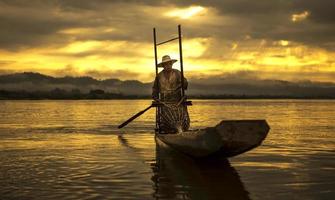Fisherman on boat catching fish