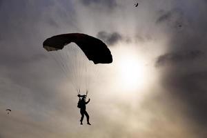skydiver silhouette against  sky photo