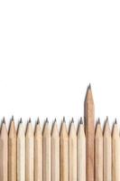 One wood pencil standing out from the row