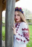 Young beautiful blonde girl with long hair in Ukrainian blouse