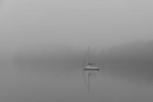 Boat on foggy lake photo