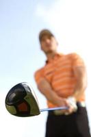 Young man playing golf, low angle view