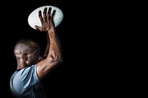 Composite image of rugby player throwing ball photo