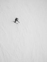 Skier sliding down slope photo