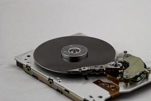 Open computer hard drive on white background photo