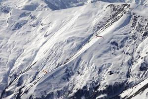Paragliders of snowy mountains