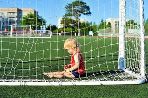 little girl baby blond playing football