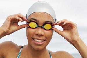 Smiling runner in goggles and swim cap photo