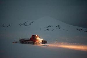 Snowcat prepares snowtrace in winter mountains of Georgia
