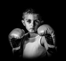 little boy boxer, on a black background