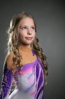 Portrait of little curly artistic gymnast
