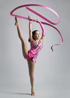 beautiful Caucasian girl gymnast with a ribbon photo