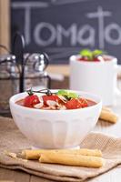 Tomato soup with baked tomatoes and breadsticks