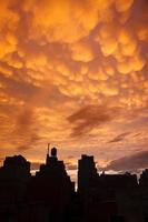 Manhattan buildings in silhouette with orange mammatus clouds at sunset photo