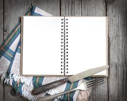 Blank cooking recipe book on wooden table photo