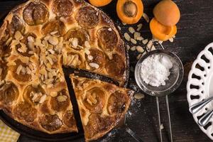 Homemade apricot tart with almonds and fresh fruits