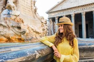 Happy woman tourist standing by the Pantheon fountain in Rome photo