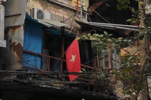 Vietnam national flag and old poor townhouse photo