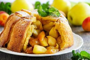 French bread Apple pie with apples and peaches. photo