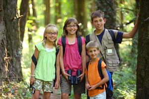 Portrait of four kids with camping gear photo