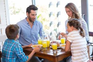 familia feliz desayunando juntos foto